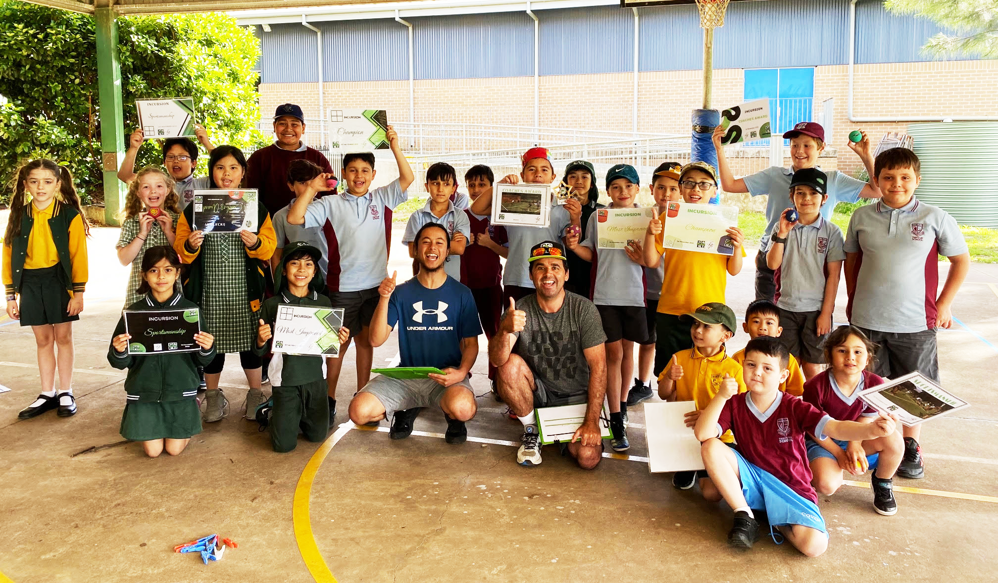 Kids having fun playing handball at an incursion holiday program